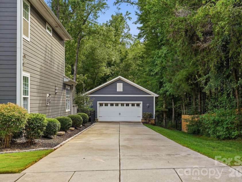 18609 Boulder Rock Loop, Davidson, NC 28036.  MLS# CAR4411962, YatesRealty ID 42335. The extra-long driveway leads directly to the detached two-car garage, offering ample off-street parking.