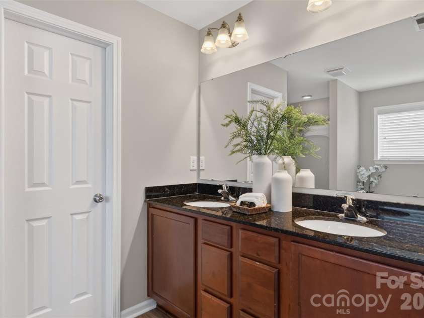 3010 Gilroy Drive, Fort Mill, SC 29707.  MLS# CAR4411123, YatesRealty ID 42343. Ensuite with dual vanity, granite counter