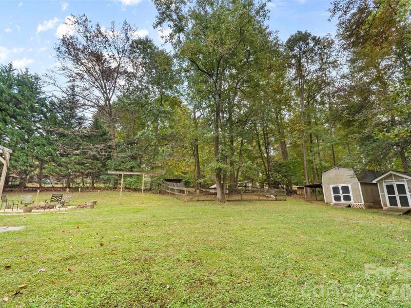 113 Sawtooth Lane, Stanley, NC 28164.  MLS# CAR4410991, YatesRealty ID 42374. Back yard with 2 storage sheds