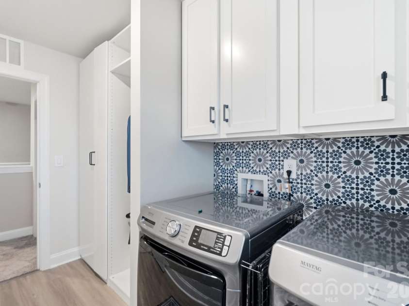 193 Adams Tree Way, Troutman, NC 28166.  MLS# CAR4405517, YatesRealty ID 42384. Storage cabinets added to laundry room for organization