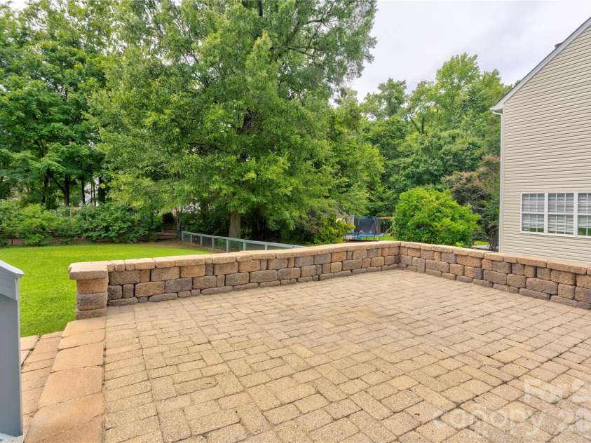 4735 Asherton Place, Concord, NC 28027.  MLS# CAR4409541, YatesRealty ID 42427. Backyard lower patio