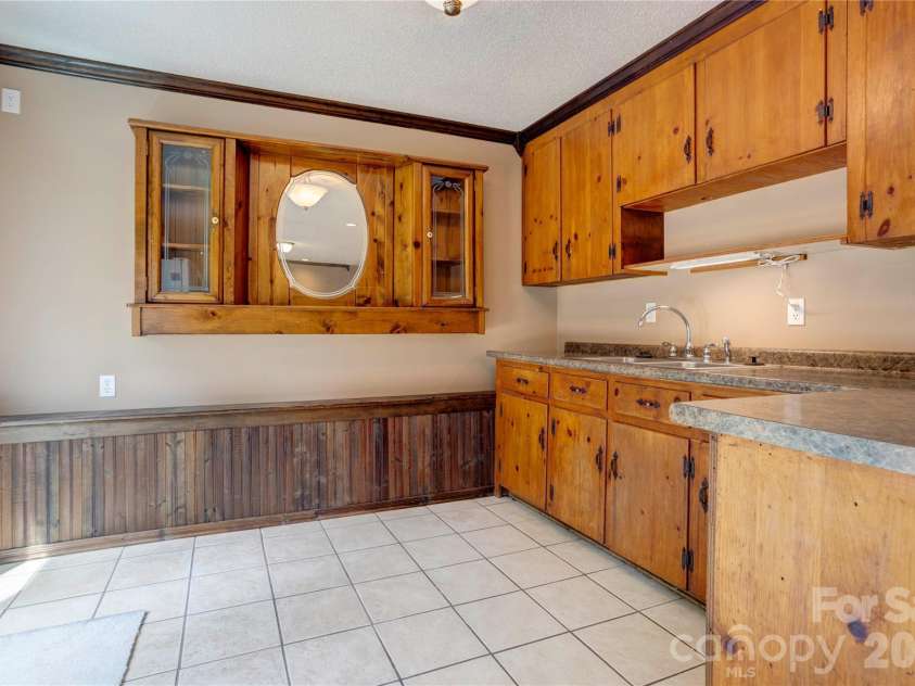 4735 Asherton Place, Concord, NC 28027.  MLS# CAR4409541, YatesRealty ID 42427. Basement wet bar area (kitchen2)