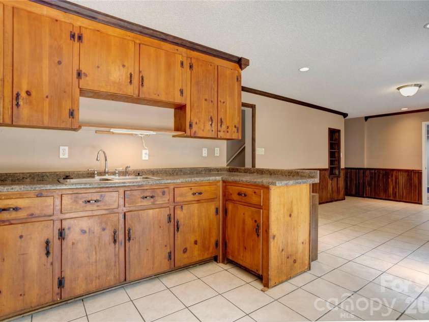 4735 Asherton Place, Concord, NC 28027.  MLS# CAR4409541, YatesRealty ID 42427. Basement wet bar area (kitchen2)