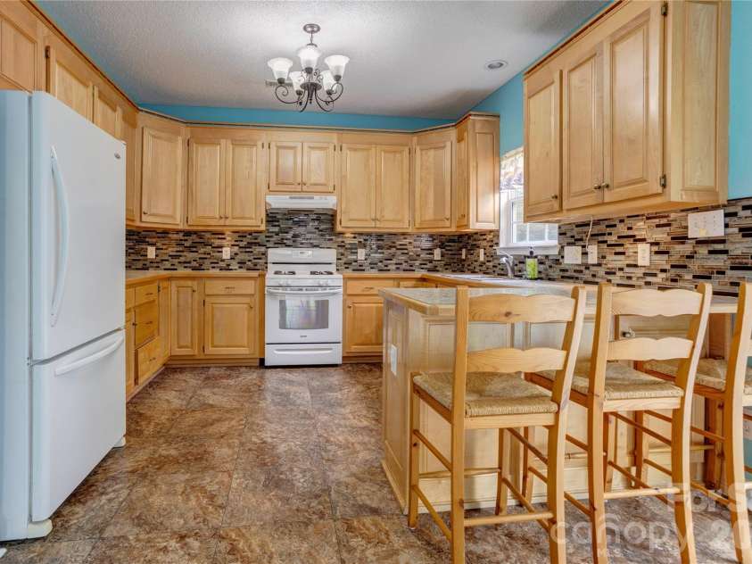 4735 Asherton Place, Concord, NC 28027.  MLS# CAR4409541, YatesRealty ID 42427. Kitchen with custom maple cabinets
