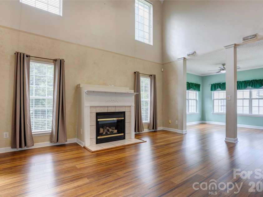 4735 Asherton Place, Concord, NC 28027.  MLS# CAR4409541, YatesRealty ID 42427. Living room with cathedral ceiling
