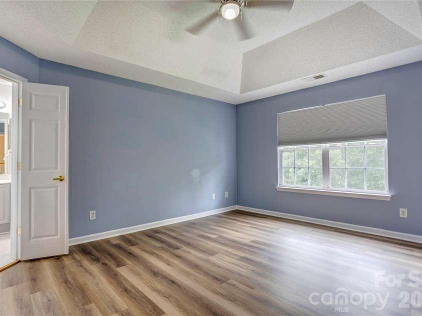 4735 Asherton Place, Concord, NC 28027.  MLS# CAR4409541, YatesRealty ID 42427. Primary bedroom with tray ceiling
