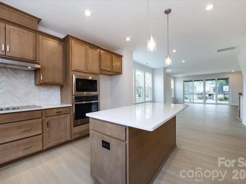 3013 Circles End, Charlotte, NC 28226.  MLS# CAR4396103, YatesRealty ID 42452. Warm brown cabinets with white quartz countertops