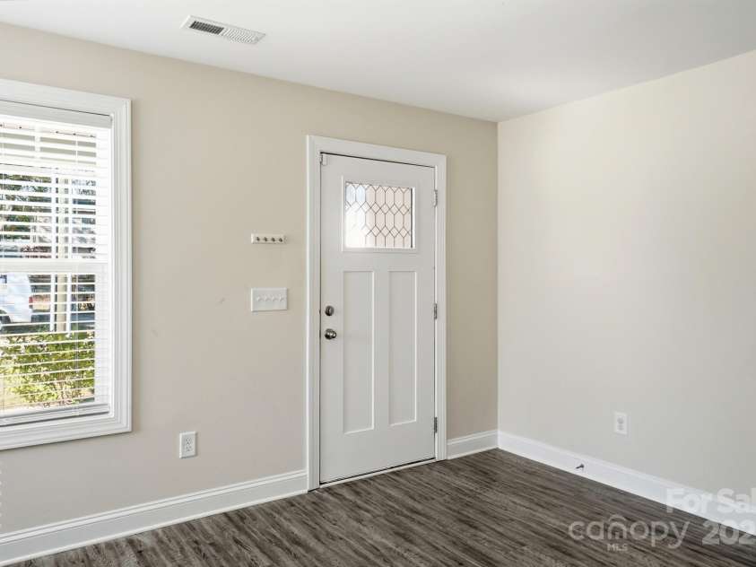 351 Center Street, Kannapolis, NC 28083.  MLS# CAR4304032, YatesRealty ID 4248. Step inside to find neutral paint and modern, durable flooring in the bright entryway, illuminated by the stylish craftsman glass front door and large window