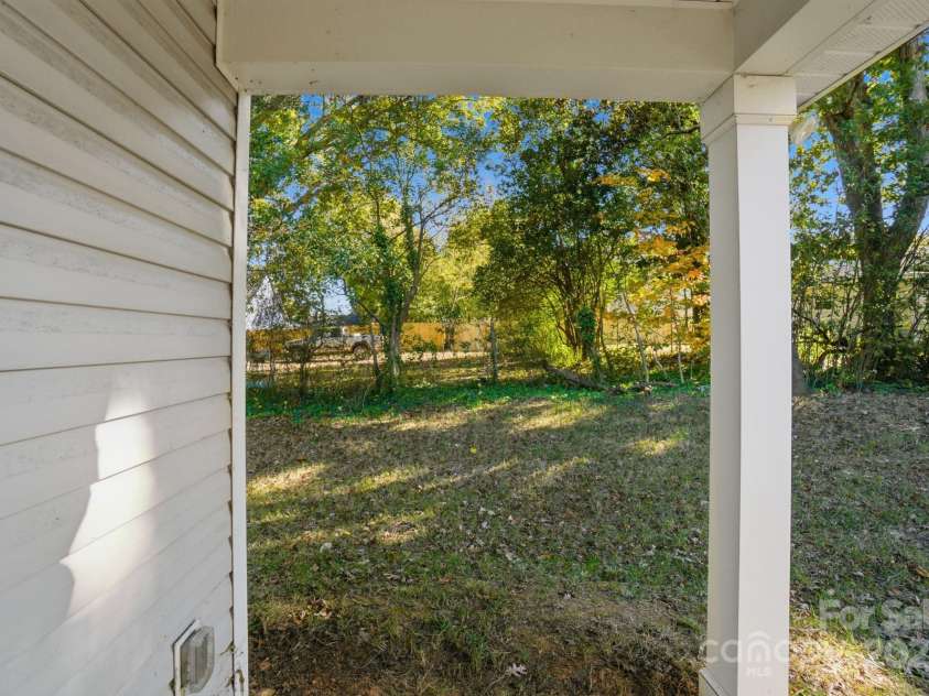 351 Center Street, Kannapolis, NC 28083.  MLS# CAR4304032, YatesRealty ID 4248. Step out to the covered back porch and enjoy the private backyard, offering a peaceful, wooded view ideal for relaxation or outdoor activities