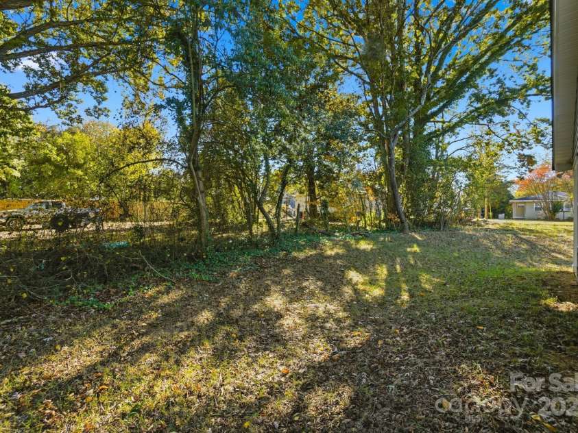 351 Center Street, Kannapolis, NC 28083.  MLS# CAR4304032, YatesRealty ID 4248. The backyard provides a generous space surrounded by mature trees for natural privacy and features bright sunlight filtering onto the lawn
