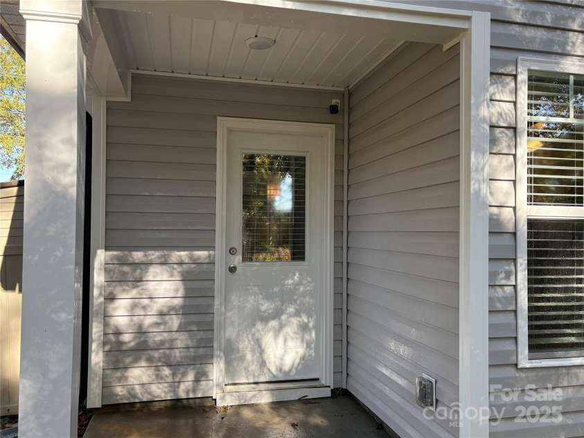 351 Center Street, Kannapolis, NC 28083.  MLS# CAR4304032, YatesRealty ID 4248. The covered back porch with a rear entry door provides convenient access to the backyard, complete with low-maintenance siding and a window for extra light in the utility area