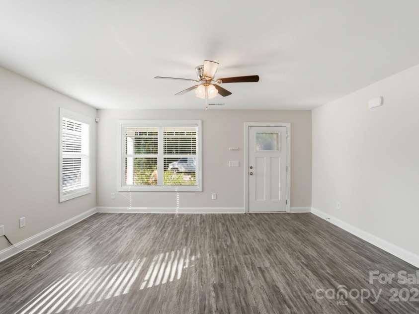 351 Center Street, Kannapolis, NC 28083.  MLS# CAR4304032, YatesRealty ID 4248. The living room is bathed in natural light streaming through the oversized windows, perfectly complementing the contemporary wood-look flooring and clean white trim