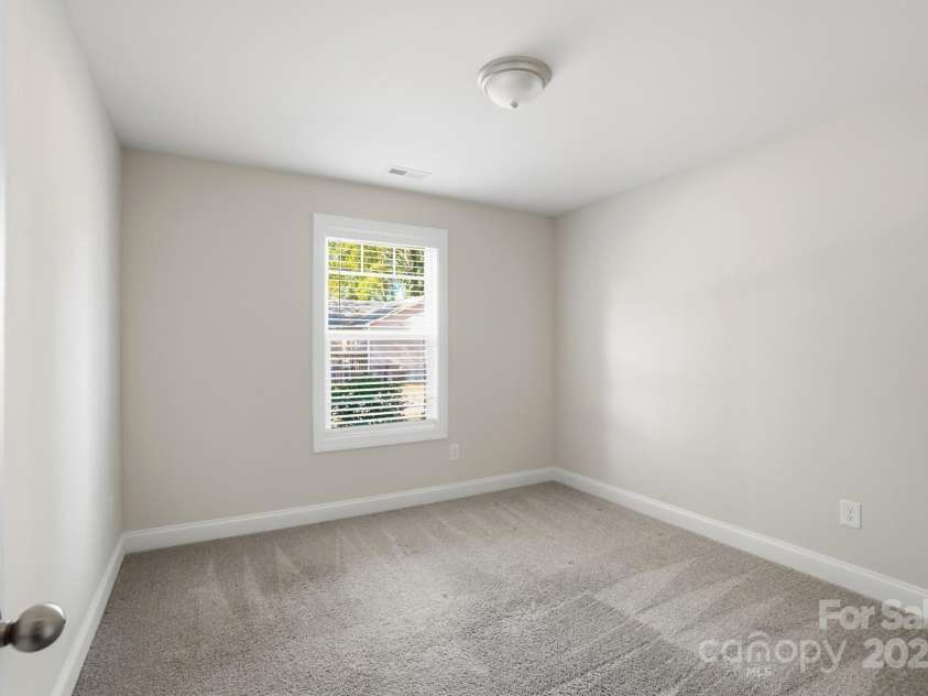 351 Center Street, Kannapolis, NC 28083.  MLS# CAR4304032, YatesRealty ID 4248. The third bedroom is equally bright and spacious, offering comfortable grey carpet, neutral paint, and an attractive window with included blinds