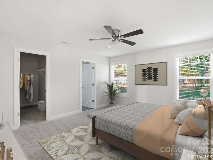 351 Center Street, Kannapolis, NC 28083.  MLS# CAR4304032, YatesRealty ID 4248. The virtually staged primary bedroom illustrates the great potential of this tranquil space, featuring plush carpeting, a ceiling fan, and access to a large walk-in closet