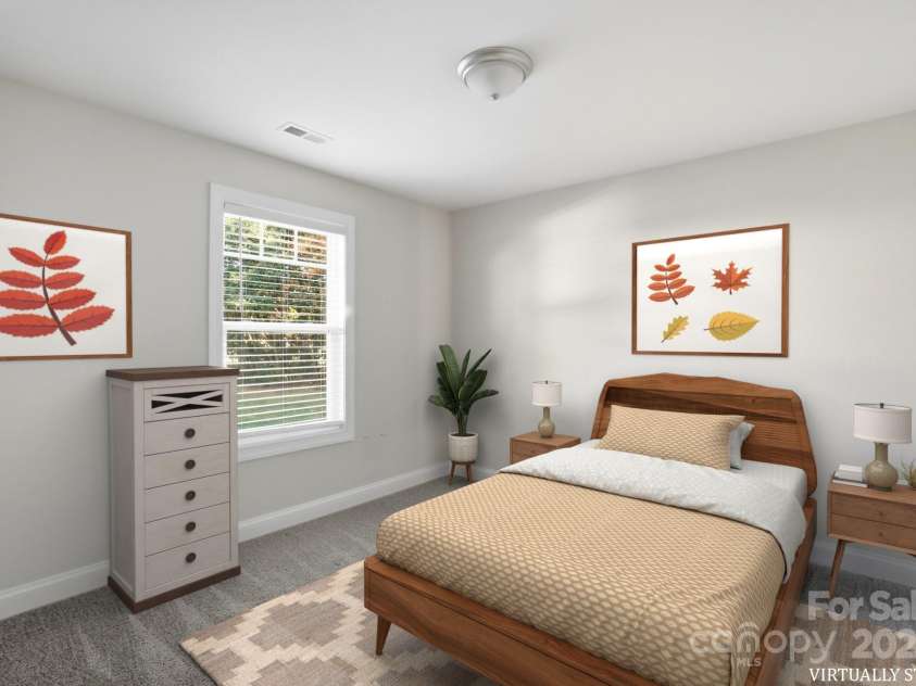 351 Center Street, Kannapolis, NC 28083.  MLS# CAR4304032, YatesRealty ID 4248. The virtually staged secondary bedroom offers a vision of comfortable living, featuring soft grey carpeting, a bright window, and generous space for a full furniture set