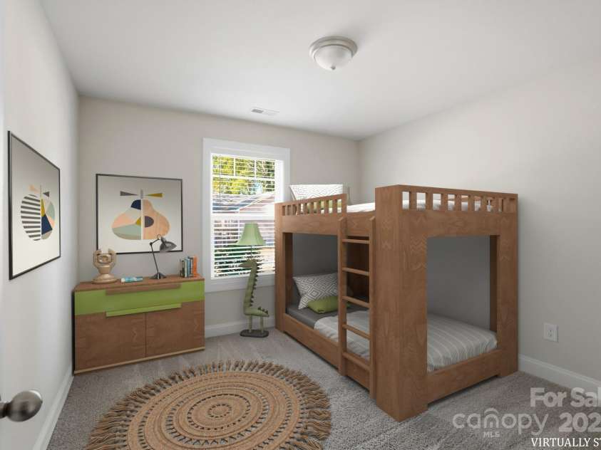 351 Center Street, Kannapolis, NC 28083.  MLS# CAR4304032, YatesRealty ID 4248. The virtually staged third bedroom demonstrates flexibility as a children's room, featuring soft carpeting, a bright window, and ample space for a bunk bed and furniture