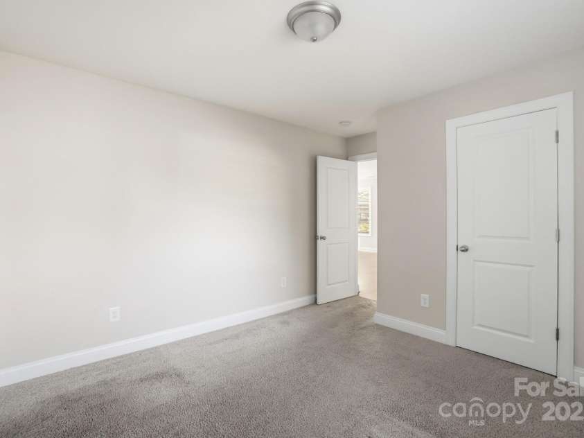 351 Center Street, Kannapolis, NC 28083.  MLS# CAR4304032, YatesRealty ID 4248. This cozy secondary bedroom is move-in ready, featuring neutral walls, plush carpeting, and a clean white six-panel closet door for ample storage