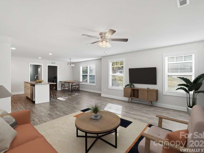 351 Center Street, Kannapolis, NC 28083.  MLS# CAR4304032, YatesRealty ID 4248. This virtually staged image highlights the spacious open-concept design, connecting the bright living area and the functional kitchen/dining space.
