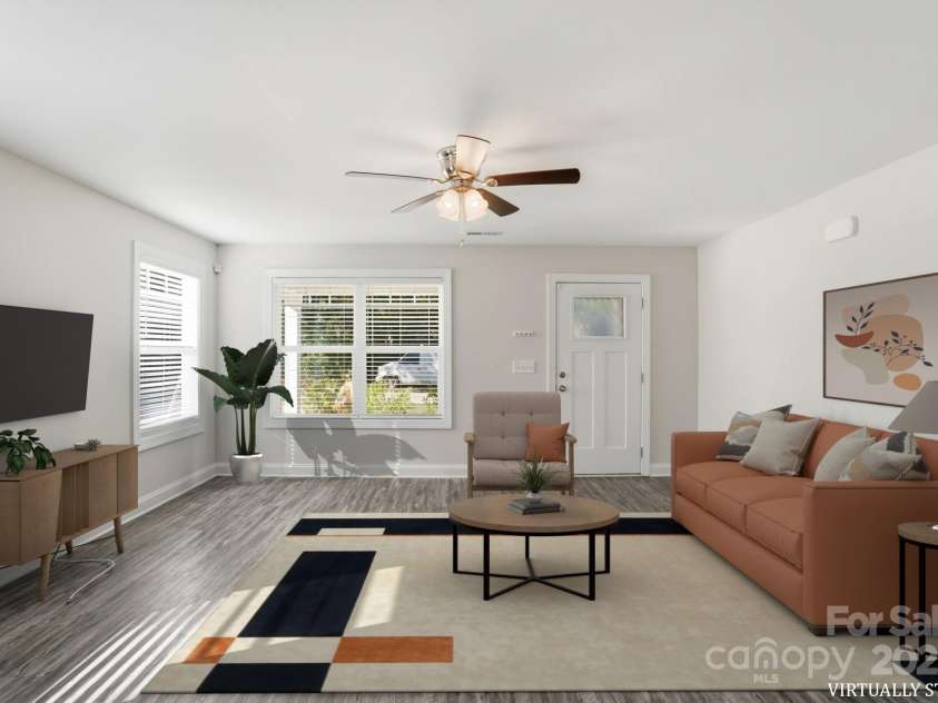 351 Center Street, Kannapolis, NC 28083.  MLS# CAR4304032, YatesRealty ID 4248. This virtually staged living area shows the incredible potential for a stylish, modern space, highlighted by the vinyl plank flooring, abundant light, and a functional ceiling fan