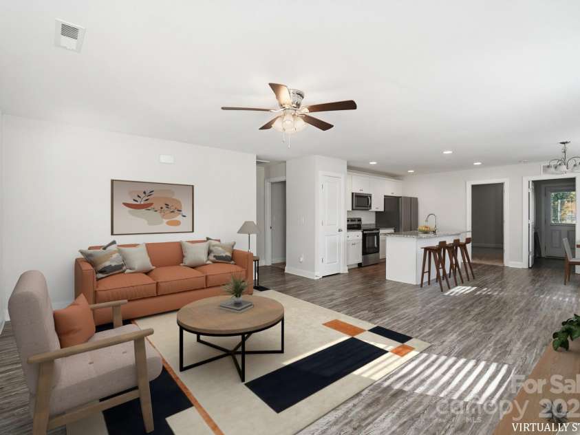 351 Center Street, Kannapolis, NC 28083.  MLS# CAR4304032, YatesRealty ID 4248. This virtually staged photo shows the spacious open-concept layout, connecting the comfortable living area seamlessly with the modern, well-equipped kitchen and dining space