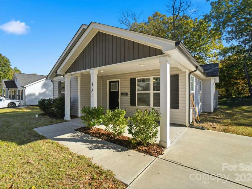 351 Center Street, Kannapolis, NC 28083.  MLS# CAR4304032, YatesRealty ID 4248. With vibrant blue skies and a poured concrete driveway, this move-in-ready home at 351 Center Street offers fantastic curb appeal and an inviting covered porch entry
