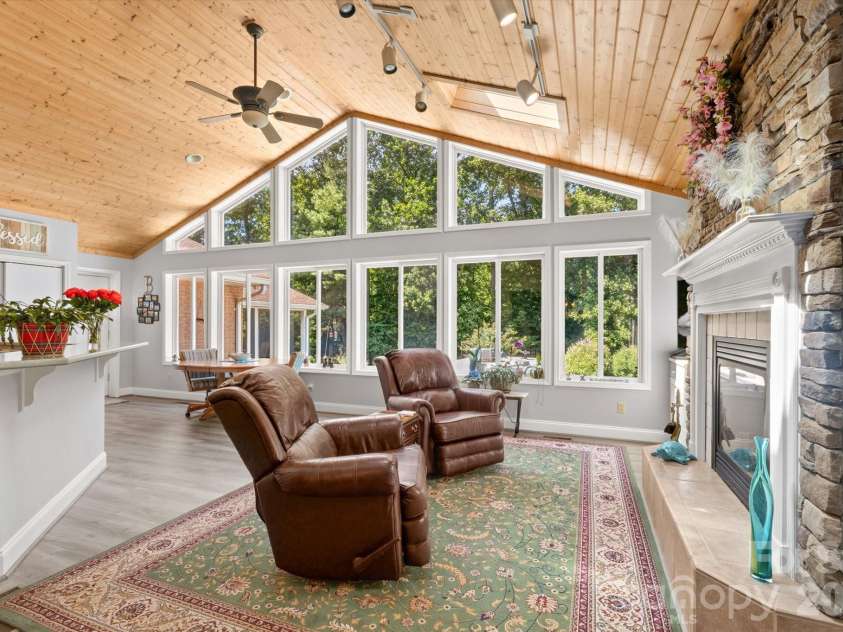 12 Highlander Lane, Hendersonville, NC 28792.  MLS# CAR4400920, YatesRealty ID 42486. Wall of windows overlooking backyard