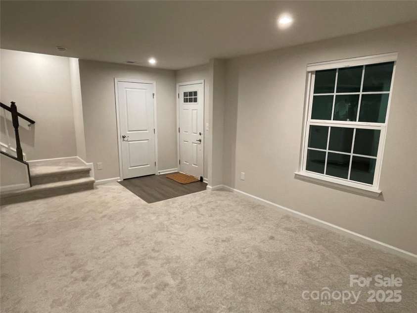 2133 Tupelo Grove Lane, Gastonia, NC 28054.  MLS# CAR4206022, YatesRealty ID 4249. Lower level bonus room with pic of front door and coat closet.