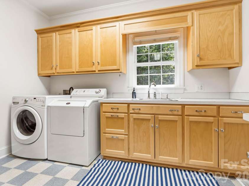 675 Heather Drive, Lincolnton, NC 28092.  MLS# CAR4410217, YatesRealty ID 42494. The built-in cabintry, along with the extra sink, makes doing laundry a sinch