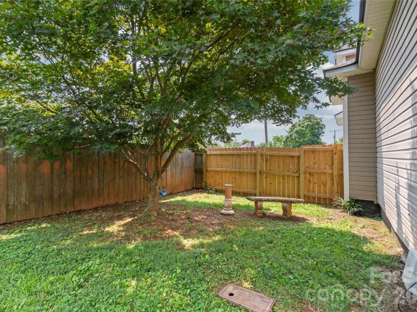 200 Park Avenue, Mount Holly, NC 28120.  MLS# CAR4407165, YatesRealty ID 42529. Back side yard with shade tree