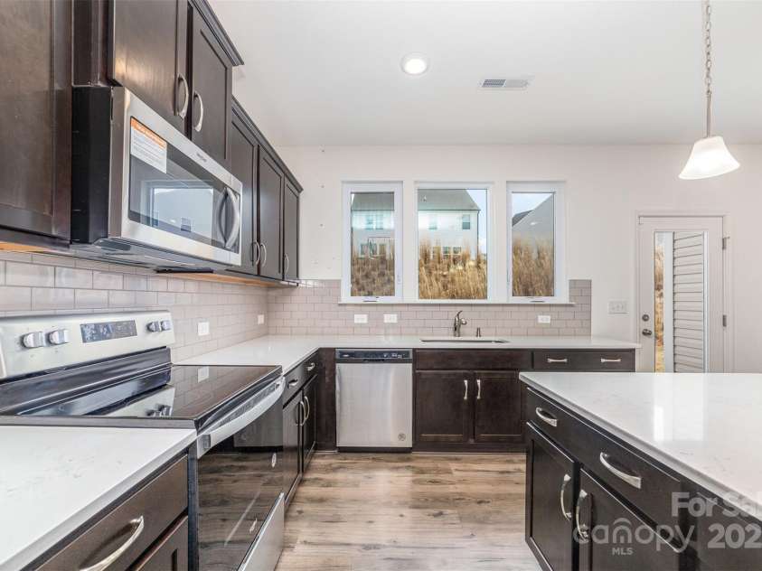 2522 Andes Drive, Statesville, NC 28625.  MLS# CAR4238678, YatesRealty ID 4254. Electric Range, Quartz Countertops, Subway Tile Backsplash, Oversized Island, Picture Window over the sink