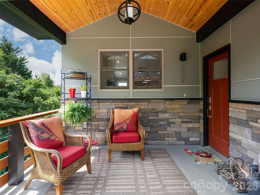 309 Ava Lane, Asheville, NC 28804.  MLS# CAR4406925, YatesRealty ID 42543. Front porch area with double windows from the kitchen allowing visual access inside or out.