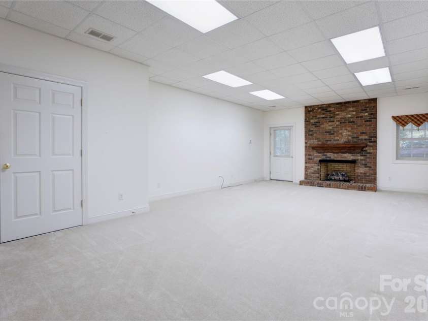 1152 Windsor Drive, Kannapolis, NC 28081.  MLS# CAR4411989, YatesRealty ID 42569. Basement Den with Fireplace & outside entry