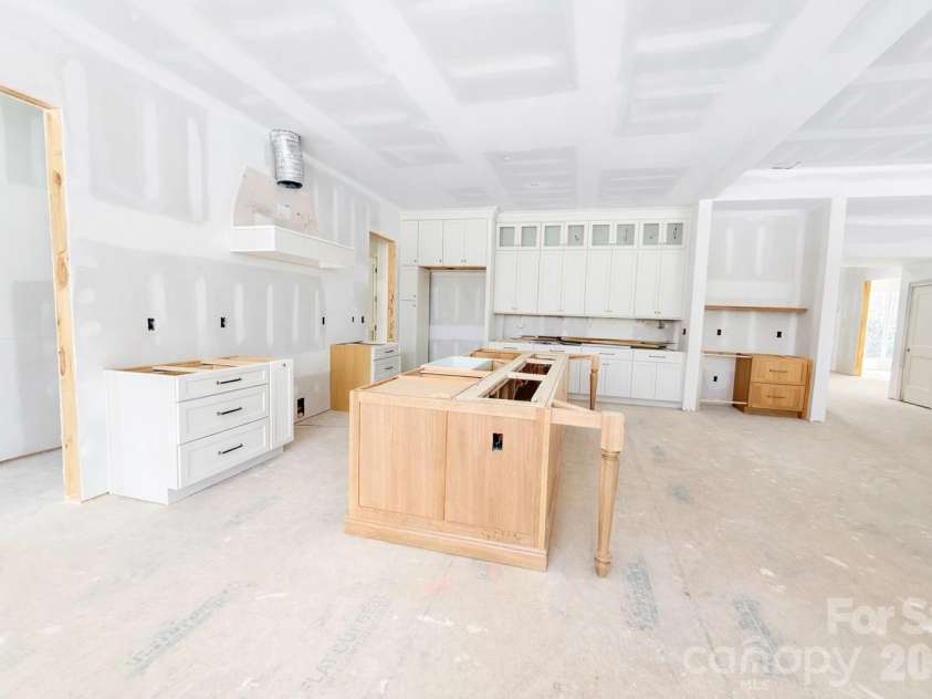 125 Randstone Court, Charlotte, NC 28211.  MLS# CAR4329471, YatesRealty ID 4258. Expansive Cabinetry- Reeded glass upper cabinets. Dry bar w/ paneled Beverage Fridge see next slide for design details & cabinet layout