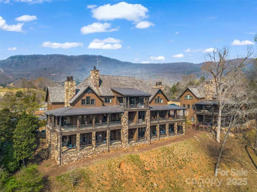 305 Clubhouse Lane, Mill Spring, NC 28756.  MLS# CAR4241690, YatesRealty ID 4258. Exquisite luxury penthouse, offering a flawless combination of sophisticated design, expansive living spaces, and panoramic mountain views