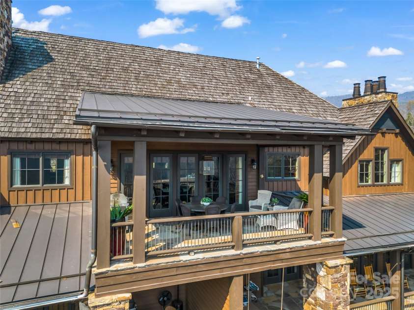 305 Clubhouse Lane, Mill Spring, NC 28756.  MLS# CAR4241690, YatesRealty ID 4258. Spacious covered terrace offering a perfect outdoor retreat,