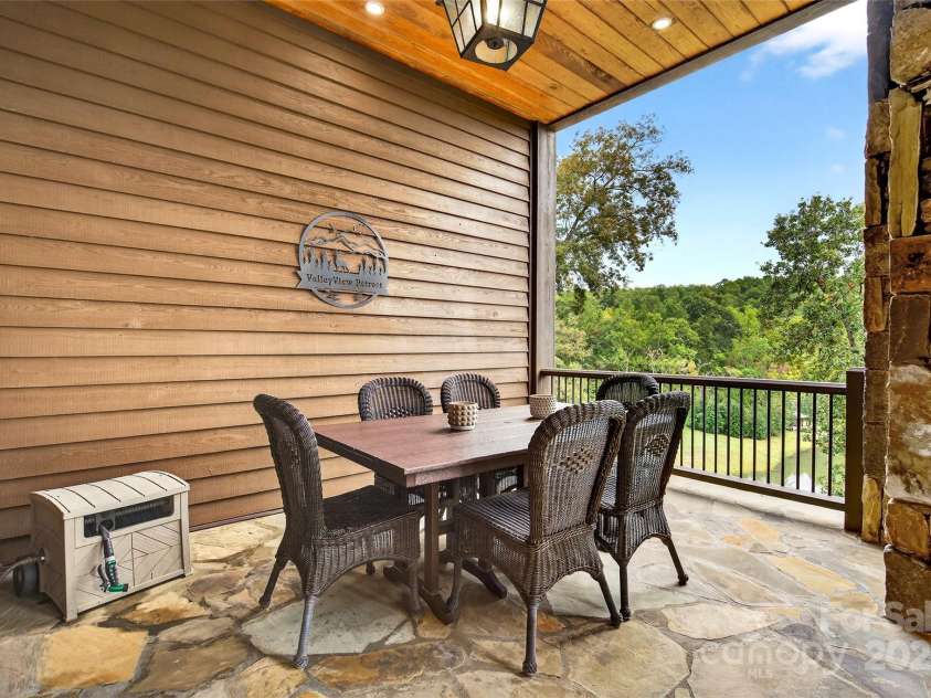 305 Clubhouse Lane, Mill Spring, NC 28756.  MLS# CAR4311469, YatesRealty ID 4258. Outdoor dining on your private porch