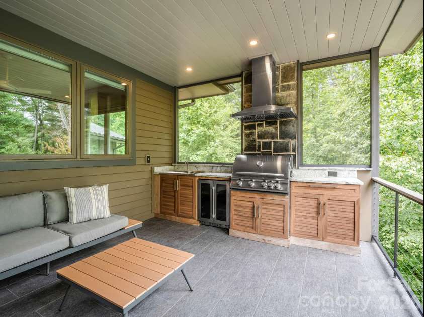 55 Pheasant Branch Court, Hendersonville, NC 28739.  MLS# CAR4406624, YatesRealty ID 42595. Back screened porch with second kitchen.