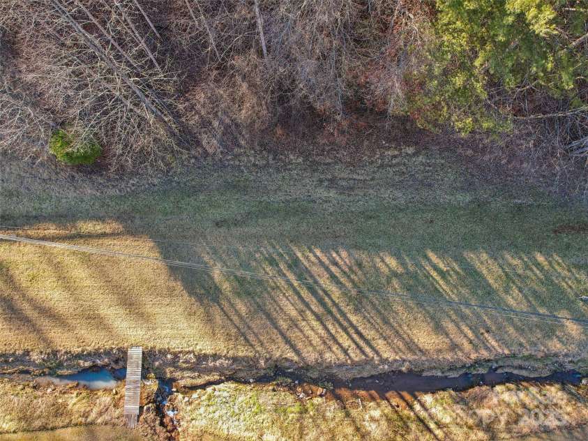 543 Hardscrabble Road, Burnsville, NC 28714.  MLS# CAR4215935, YatesRealty ID 4260. Flat area and creek frontage