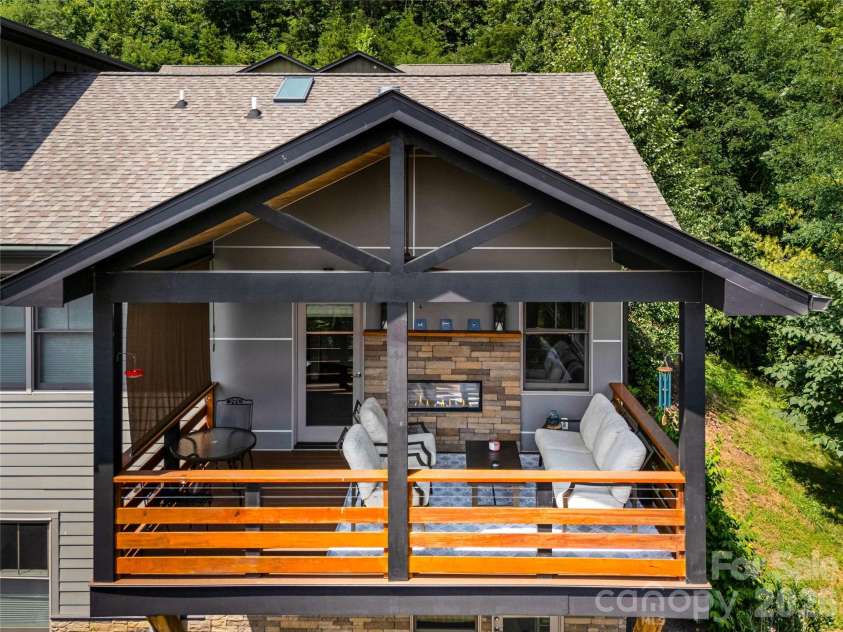 409 Kessler Place, Asheville, NC 28804.  MLS# CAR4410858, YatesRealty ID 42650. Covered deck with fireplace