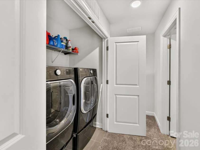 4552 Millennium Avenue, Charlotte, NC 28217.  MLS# CAR4405822, YatesRealty ID 42662. Convenient upper-level laundry area offers everyday functionality with built-in shelving for added storage and organization.