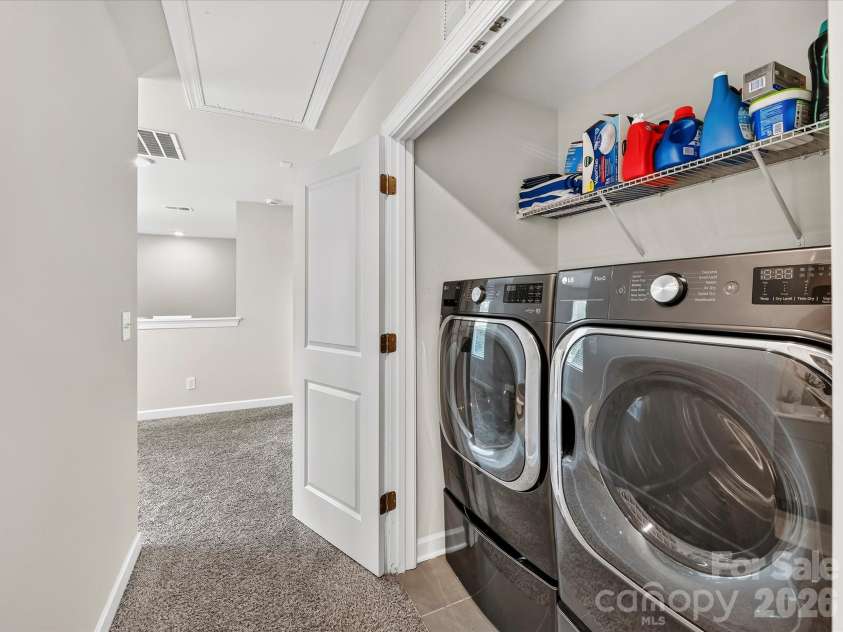 4552 Millennium Avenue, Charlotte, NC 28217.  MLS# CAR4405822, YatesRealty ID 42662. Convenient upper-level laundry area offers everyday functionality with built-in shelving for added storage and organization.