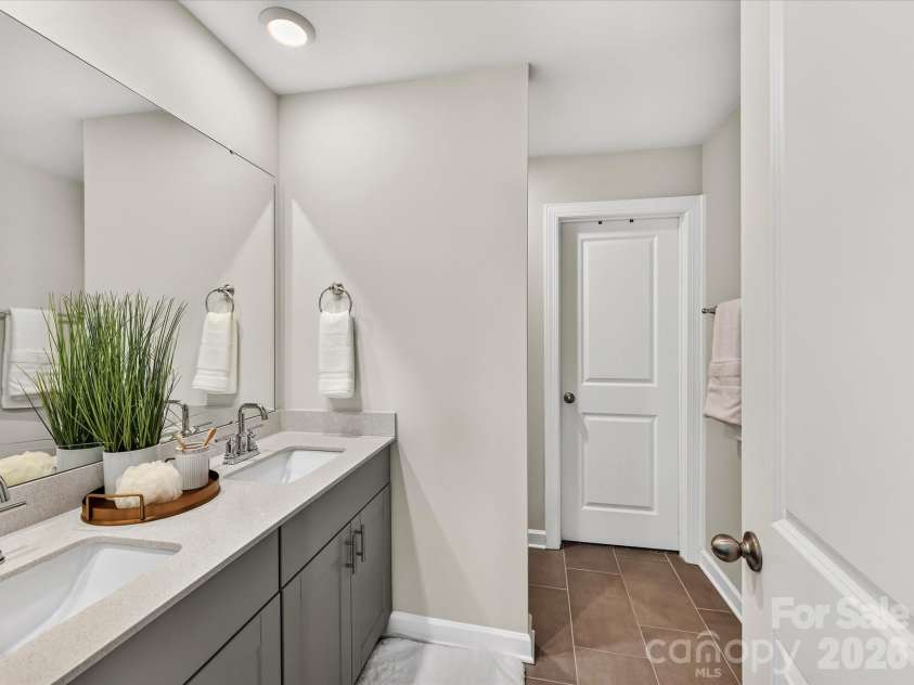 4552 Millennium Avenue, Charlotte, NC 28217.  MLS# CAR4405822, YatesRealty ID 42662. Spa-inspired primary bathroom features dual vanities, a spacious walk-in shower, and ample storage.