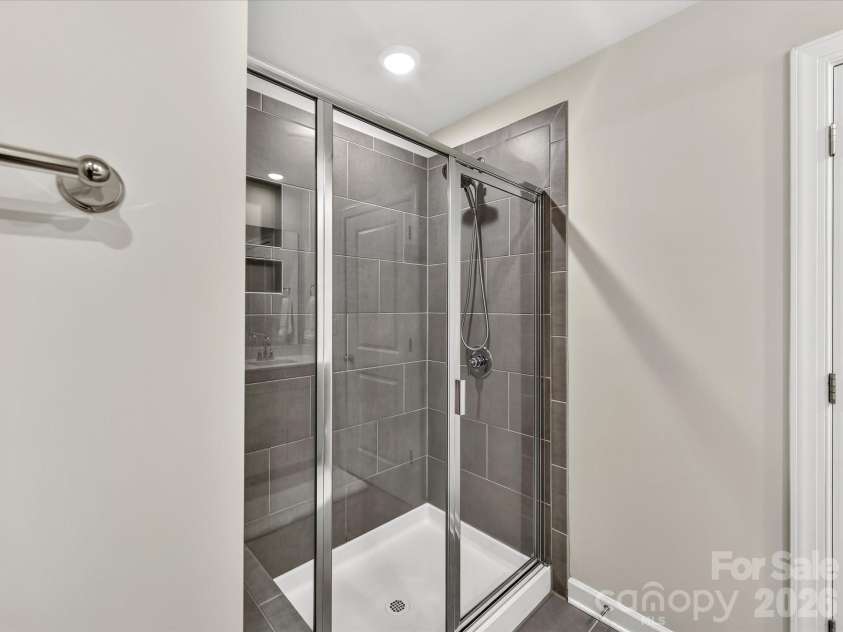 4552 Millennium Avenue, Charlotte, NC 28217.  MLS# CAR4405822, YatesRealty ID 42662. Spa-inspired primary bathroom features dual vanities, a spacious walk-in shower, and ample storage.