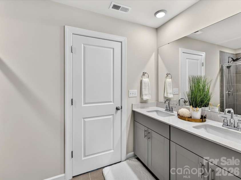 4552 Millennium Avenue, Charlotte, NC 28217.  MLS# CAR4405822, YatesRealty ID 42662. Spa-inspired primary bathroom features dual vanities, a spacious walk-in shower, and ample storage.