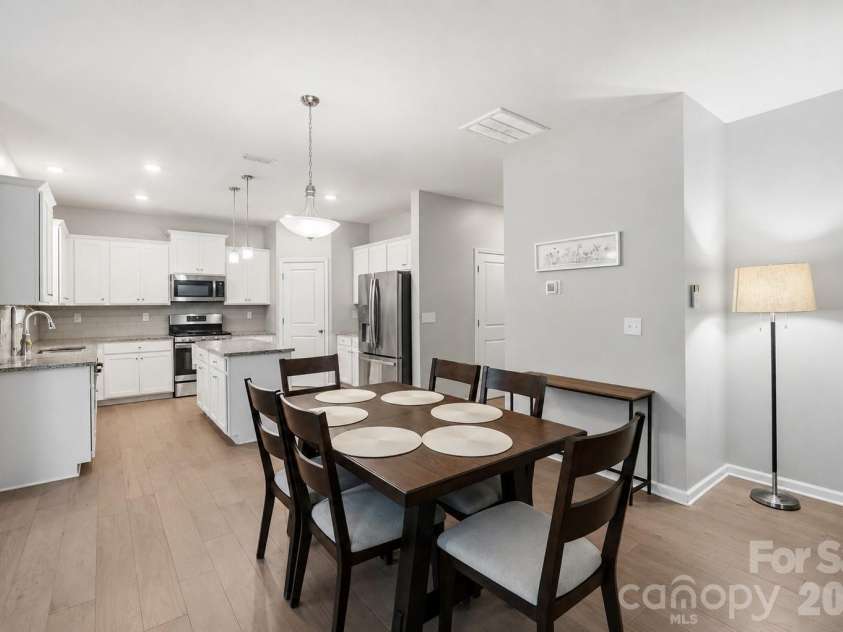 437 Caleb Street, Monroe, NC 28110.  MLS# CAR4407265, YatesRealty ID 42738. Crisp white kitchen with a center island built for gathering and weeknight dinners