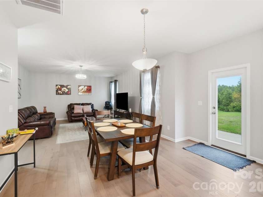 437 Caleb Street, Monroe, NC 28110.  MLS# CAR4407265, YatesRealty ID 42738. Sunlit dining area with backyard access, ideal for everyday meals and gathering.