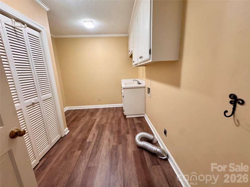 271 Ikerd Drive, Concord, NC 28025.  MLS# CAR4396759, YatesRealty ID 4274. Laundry room with storage closet and sink