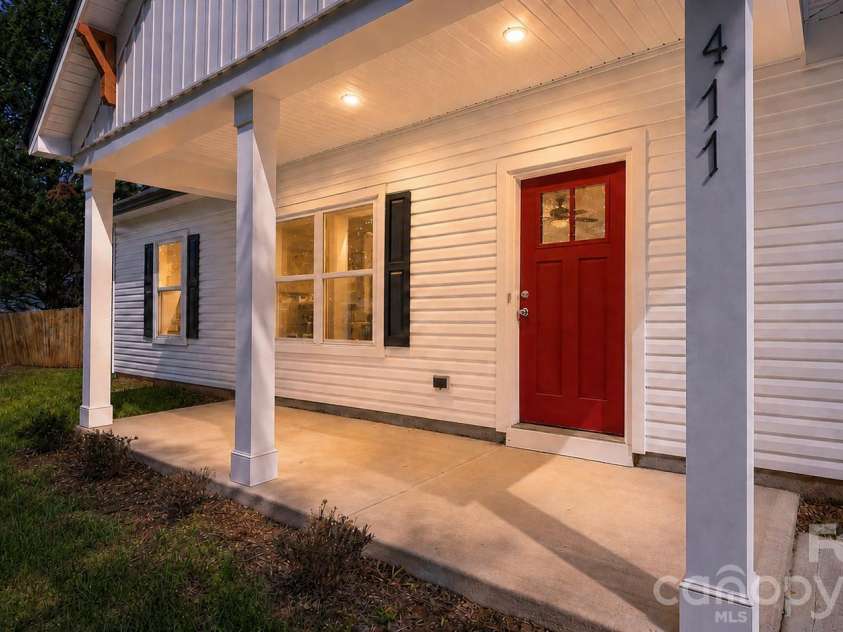 411 Grim Street, Salisbury, NC 28144.  MLS# CAR4404911, YatesRealty ID 42743. The inviting front elevation showcases a vibrant red entry door, handcrafted cedar corbels, and thoughtfully designed architectural details that instantly feel like home.