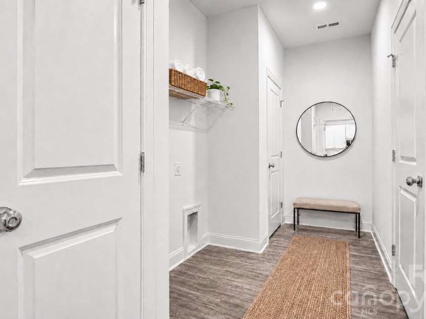 411 Grim Street, Salisbury, NC 28144.  MLS# CAR4404911, YatesRealty ID 42743. Virtually staged utility room with pantry storage, creating a welcoming and practical walkway to the laundry area.