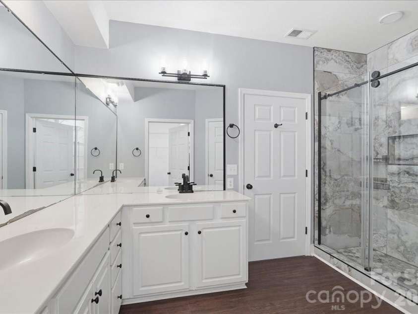 14817 Santa Lucia Drive, Charlotte, NC 28277.  MLS# CAR4412979, YatesRealty ID 42768. HUGE PRIMARY ENSUITE WITH DOUBLE CORNER VANITIES STAND UP SHOWER